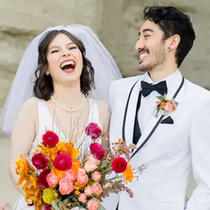 Laughing newlyweds in white